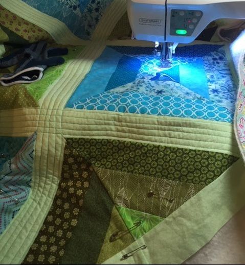 Picture, string quilt being quilted on a home sewing machine.